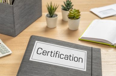 A folder on a desk with the label Certification