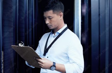 Data center, man and technician with clipboard in server room for solution, maintenance or software update. Cyber, checklist and person with document for inspection, configuration or system report