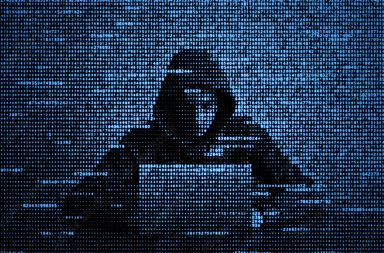 Hacker in data security concept. Hacker using laptop. Hacking the Internet. Cyber attack.