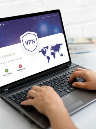 Using a VPN on a laptop. Web page concept with VPN connection and world map, emphasizing global online security and privacy