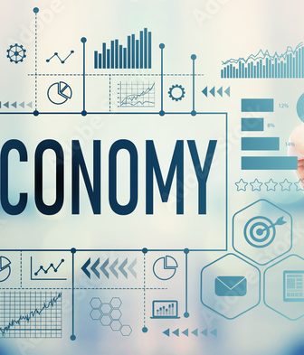 Economy with businessman on blurred abstract background